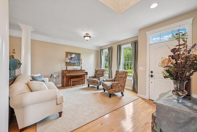 6150 Heritage Lakes Dr, Hilliard, OH 43026 - living area with light wood finished floors, crown molding, recessed lighting, and decorative columns