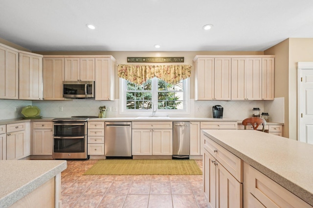 6150 Heritage Lakes Dr, Hilliard, OH 43026 - kitchen with stainless steel appliances, light countertops, decorative backsplash, recessed lighting, and light tile patterned floors