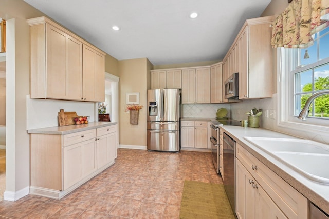 6150 Heritage Lakes Dr, Hilliard, OH 43026 - kitchen with appliances with stainless steel finishes, light countertops, decorative backsplash, recessed lighting, and light brown cabinets