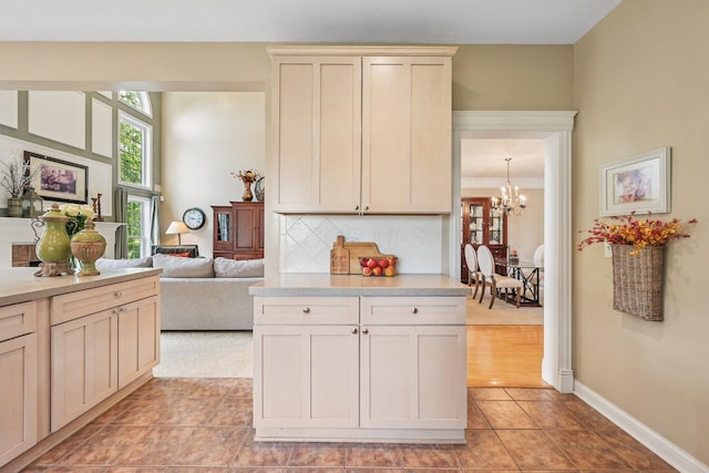 6150 Heritage Lakes Dr, Hilliard, OH 43026 - kitchen featuring a chandelier, light countertops, light tile patterned floors, and backsplash
