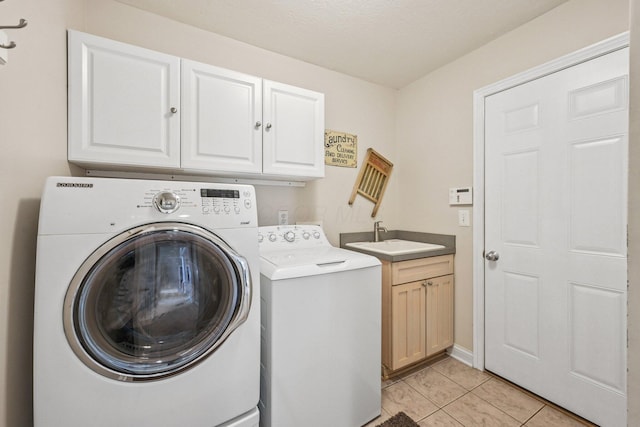 6150 Heritage Lakes Dr, Hilliard, OH 43026 - laundry area featuring cabinet space, independent washer and dryer, and light tile patterned floors