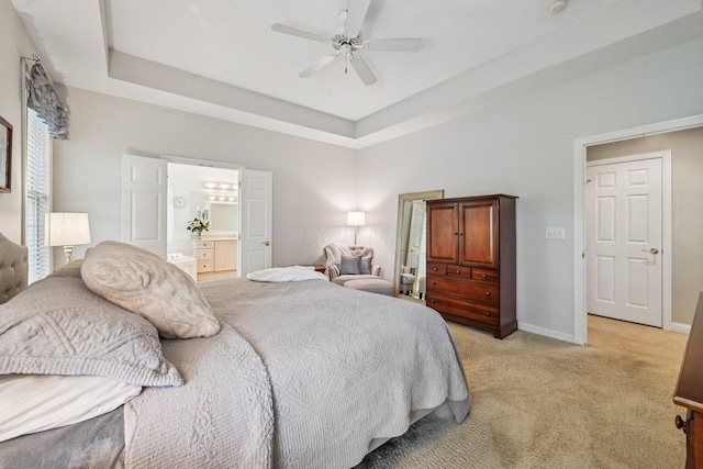 6150 Heritage Lakes Dr, Hilliard, OH 43026 - bedroom with light carpet, a raised ceiling, ensuite bath, and ceiling fan