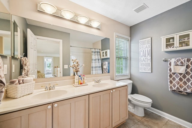 6150 Heritage Lakes Dr, Hilliard, OH 43026 - full bath with double vanity, healthy amount of natural light, tile patterned flooring, and a shower with curtain
