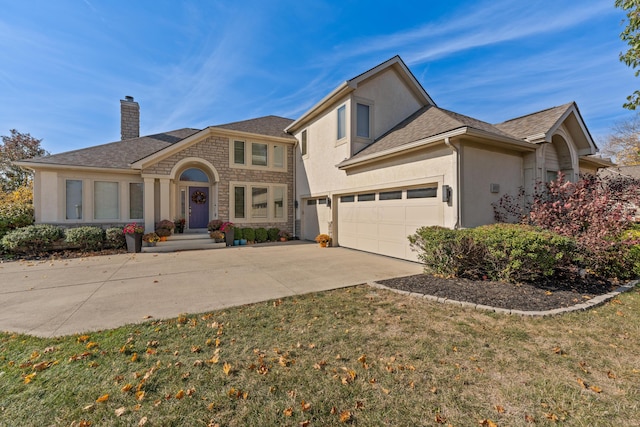 6037 Baronscourt Way, Dublin, OH 43016 - view of front of house featuring a chimney, stucco siding, concrete driveway, stone siding, and a front lawn