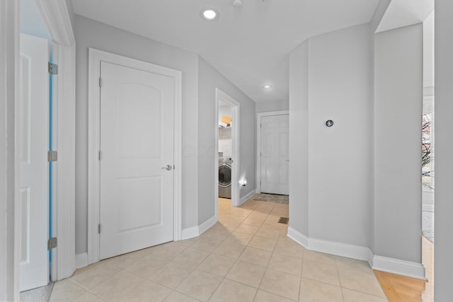6037 Baronscourt Way, Dublin, OH 43016 - corridor with washer / dryer, recessed lighting, and light tile patterned flooring