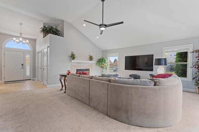 6037 Baronscourt Way, Dublin, OH 43016 - living area featuring high vaulted ceiling, light carpet, healthy amount of natural light, a chandelier, and a glass covered fireplace