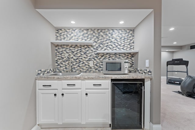 6037 Baronscourt Way, Dublin, OH 43016 - kitchen with beverage cooler, stainless steel microwave, tasteful backsplash, recessed lighting, and white cabinets