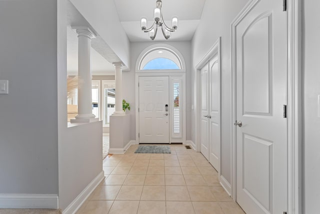 6037 Baronscourt Way, Dublin, OH 43016 - foyer entrance with decorative columns, light tile patterned floors, and a chandelier
