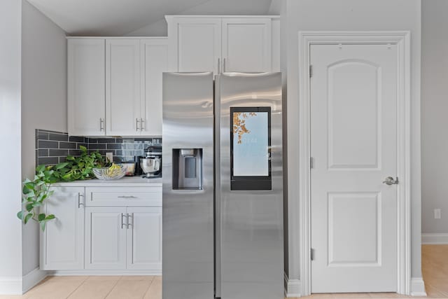 6037 Baronscourt Way, Dublin, OH 43016 - kitchen with stainless steel fridge, white cabinets, light tile patterned flooring, and light countertops