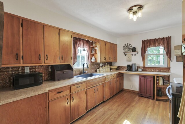 17519 Thompson Ridge Rd, Laurelville, OH 43135 - kitchen featuring black microwave, healthy amount of natural light, decorative backsplash, and light wood finished floors
