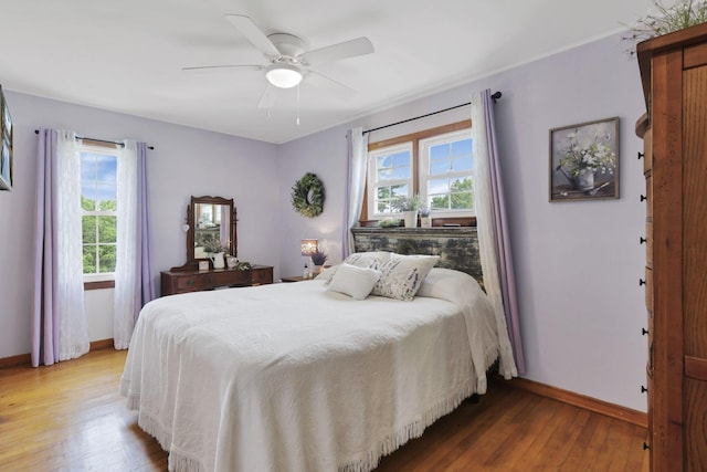 17519 Thompson Ridge Rd, Laurelville, OH 43135 - bedroom featuring light wood-style floors, multiple windows, and ceiling fan