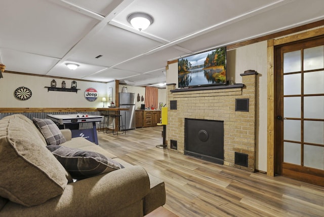 17519 Thompson Ridge Rd, Laurelville, OH 43135 - living room featuring light wood-style floors, a fireplace, wood walls, and bar area