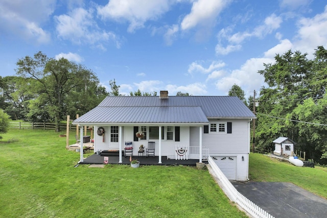 17519 Thompson Ridge Rd, Laurelville, OH 43135 - view of front of home with a porch, asphalt driveway, an attached garage, a metal roof, and a chimney