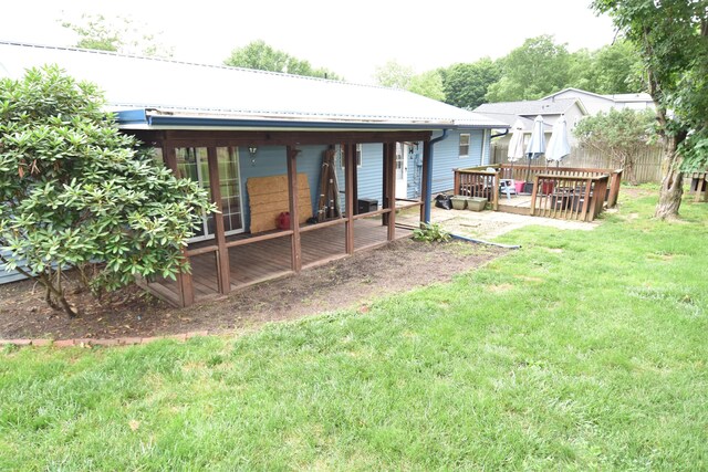 566 Deanna Stroll Rd, Heath, OH 43056 - back of house with a wooden deck, a lawn, a metal roof, and a sunroom