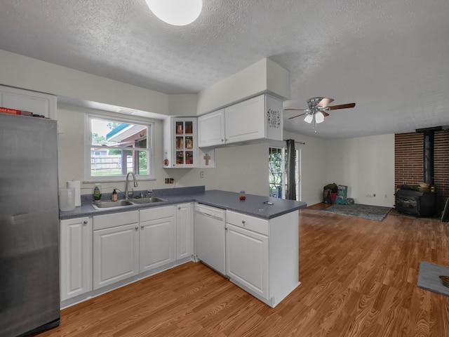 566 Deanna Stroll Rd, Heath, OH 43056 - kitchen featuring freestanding refrigerator, dishwasher, light wood finished floors, a wood stove, and ceiling fan