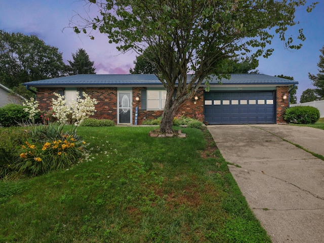 566 Deanna Stroll Rd, Heath, OH 43056 - ranch-style home with a garage, driveway, a lawn, and brick siding
