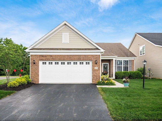 8105 Jitterbug Ln, Pickerington, OH 43147 - view of front of home with brick siding, asphalt driveway, a front lawn, and a garage