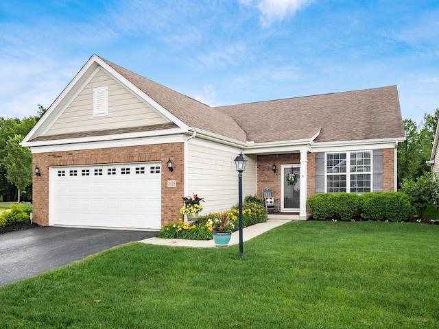 8105 Jitterbug Ln, Pickerington, OH 43147 - view of front of property with brick siding, asphalt driveway, a front lawn, an attached garage, and a shingled roof