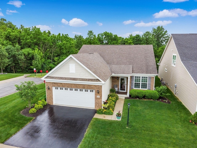 8105 Jitterbug Ln, Pickerington, OH 43147 - view of front of home with brick siding, driveway, a front yard, and an attached garage