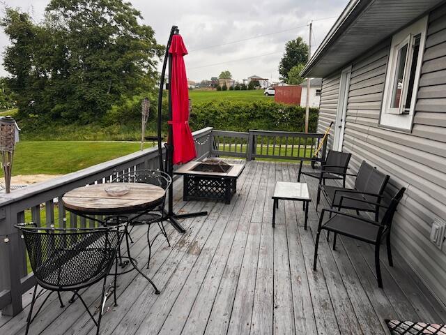 67682 Morristown Flushing Rd, Belmont, OH 43718 - wooden deck featuring an outdoor fire pit and a yard