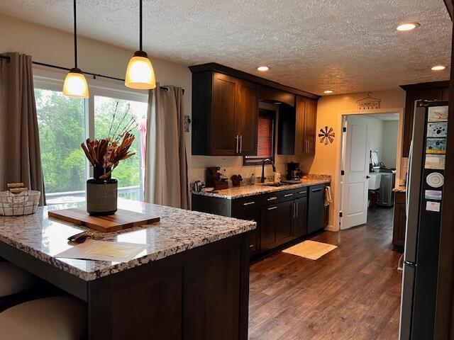 67682 Morristown Flushing Rd, Belmont, OH 43718 - kitchen with a textured ceiling, black dishwasher, dark wood finished floors, recessed lighting, and light stone countertops