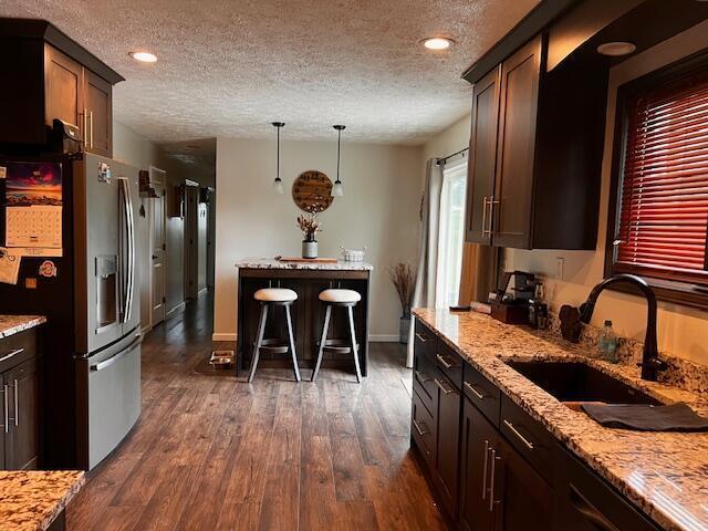 67682 Morristown Flushing Rd, Belmont, OH 43718 - kitchen featuring stainless steel fridge with ice dispenser, a textured ceiling, dark wood-style floors, light stone counters, and recessed lighting