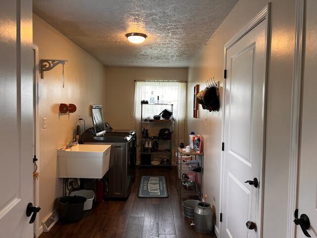 67682 Morristown Flushing Rd, Belmont, OH 43718 - washroom featuring a textured ceiling, washing machine and clothes dryer, and hardwood / wood-style flooring