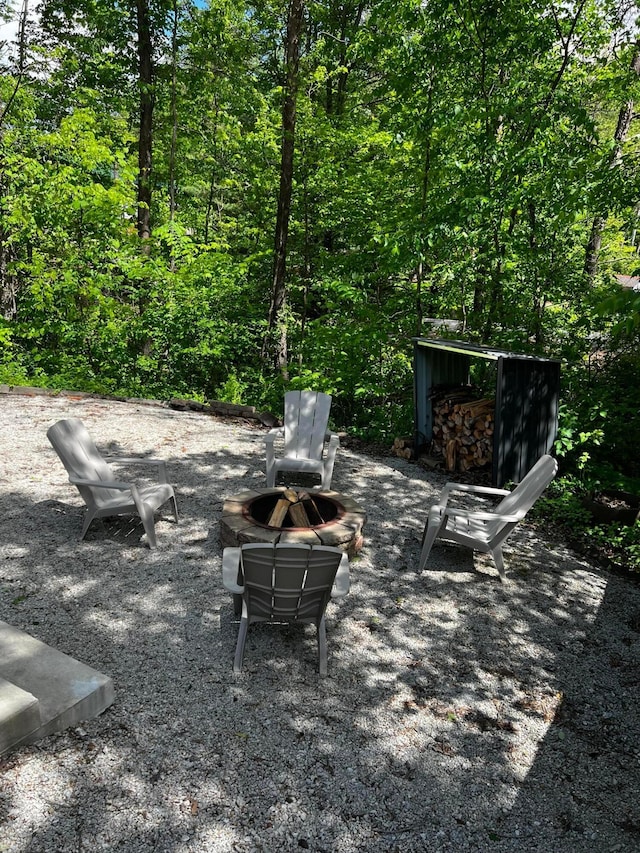 374 Pathfinder Trl, Logan, OH 43138 - view of patio with an outdoor fire pit and a forest view