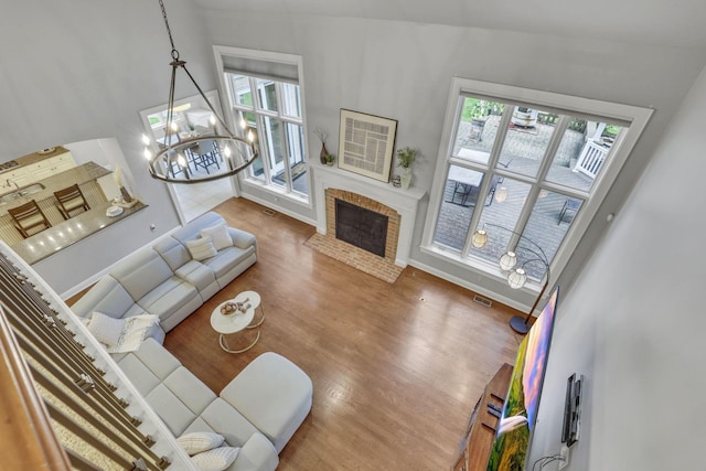4329 Wyandotte Woods Blvd, Dublin, OH 43016 - living room featuring plenty of natural light, wood finished floors, a chandelier, and a fireplace with flush hearth