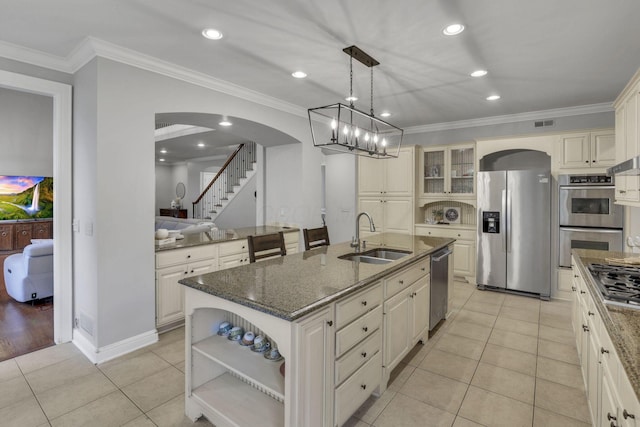 4329 Wyandotte Woods Blvd, Dublin, OH 43016 - kitchen with stainless steel appliances, arched walkways, open shelves, dark stone countertops, and an island with sink