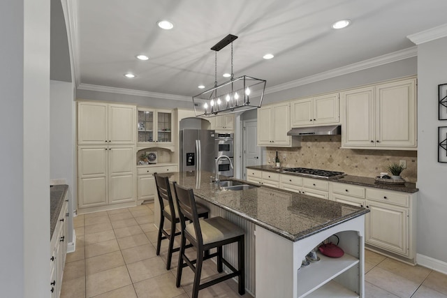 4329 Wyandotte Woods Blvd, Dublin, OH 43016 - kitchen featuring cream cabinets, appliances with stainless steel finishes, under cabinet range hood, ornamental molding, and light tile patterned floors