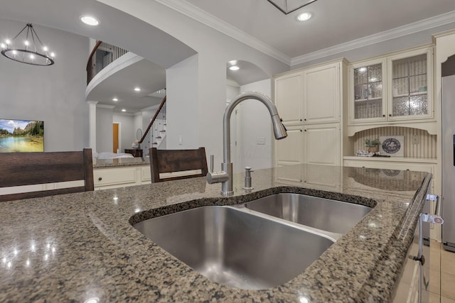 4329 Wyandotte Woods Blvd, Dublin, OH 43016 - kitchen view of arched walkways, dark stone countertops, crown molding, ornate columns, and recessed lighting