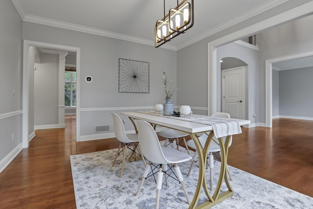 4329 Wyandotte Woods Blvd, Dublin, OH 43016 - dining area with arched walkways, wood finished floors, crown molding, and a chandelier