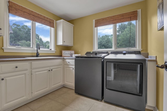 4329 Wyandotte Woods Blvd, Dublin, OH 43016 - laundry area featuring cabinet space, independent washer and dryer, light tile patterned floors, and healthy amount of natural light