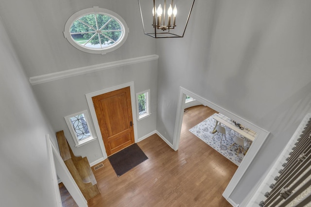 4329 Wyandotte Woods Blvd, Dublin, OH 43016 - foyer entrance featuring a high ceiling, a chandelier, and wood finished floors