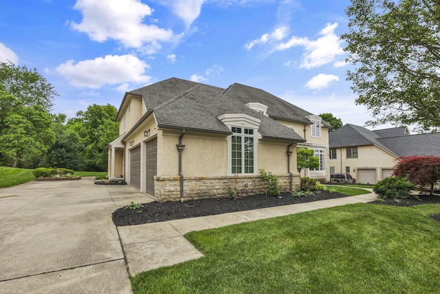 4329 Wyandotte Woods Blvd, Dublin, OH 43016 - view of front of house with concrete driveway, stone siding, stucco siding, a front lawn, and a garage