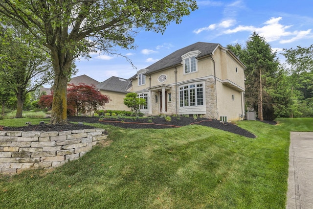 4329 Wyandotte Woods Blvd, Dublin, OH 43016 - french provincial home featuring a front yard, stucco siding, and stone siding