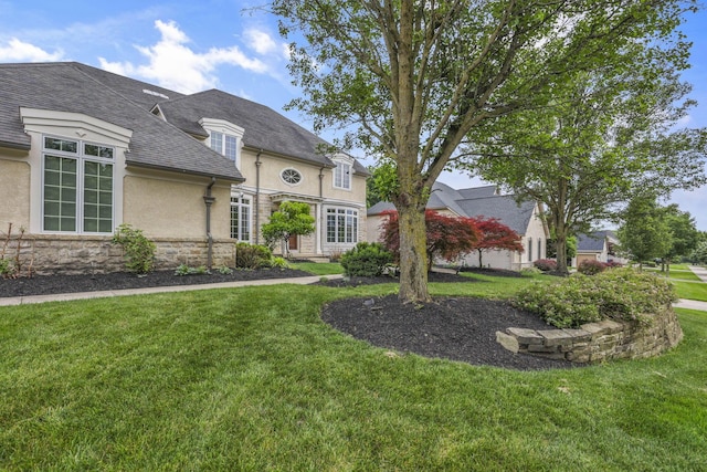 4329 Wyandotte Woods Blvd, Dublin, OH 43016 - french provincial home featuring stone siding, stucco siding, a front yard, and a shingled roof