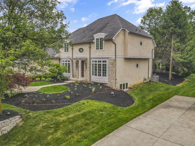 4329 Wyandotte Woods Blvd, Dublin, OH 43016 - french country style house with stucco siding, a front yard, and stone siding