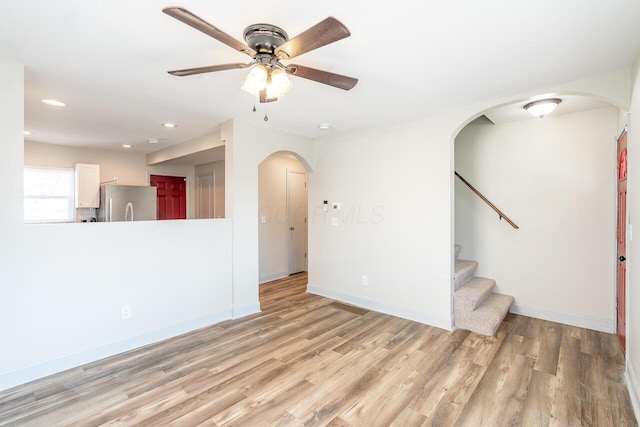 1096 E 22nd Ave Unit 1098, Columbus, OH 43211 - unfurnished living room with arched walkways, ceiling fan, wood finished floors, recessed lighting, and stairway