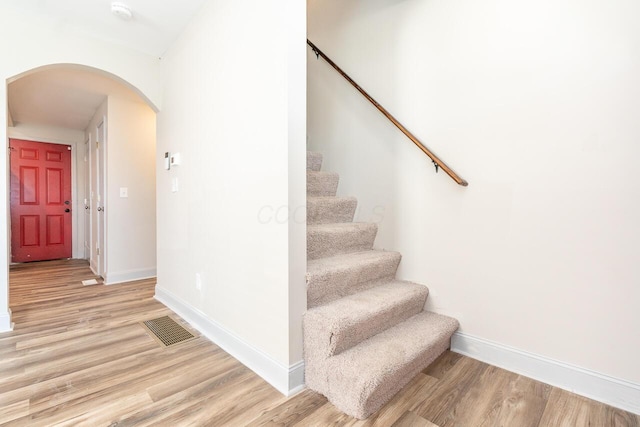 1096 E 22nd Ave Unit 1098, Columbus, OH 43211 - staircase featuring arched walkways and wood finished floors