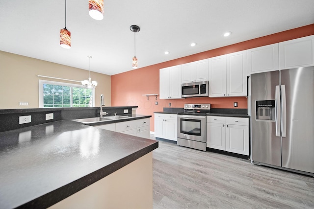 786 Spring Valley Dr, Lewis Center, OH 43035 - kitchen with appliances with stainless steel finishes, dark countertops, light wood-style floors, decorative light fixtures, and recessed lighting