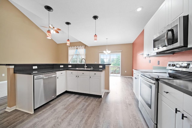 786 Spring Valley Dr, Lewis Center, OH 43035 - kitchen featuring stainless steel appliances, light wood-type flooring, dark countertops, white cabinetry, and lofted ceiling