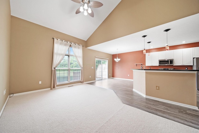 786 Spring Valley Dr, Lewis Center, OH 43035 - unfurnished living room with light colored carpet, a ceiling fan, a chandelier, high vaulted ceiling, and recessed lighting