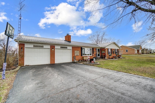 1849 Old Springfield Rd, New Holland, OH 43145 - ranch-style house with brick siding, an attached garage, asphalt driveway, and a front lawn