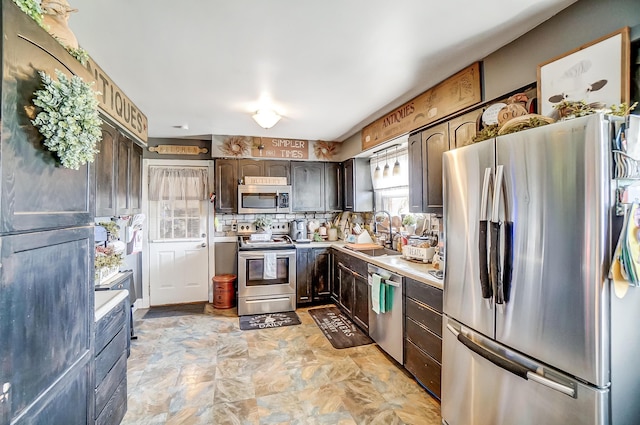 1849 Old Springfield Rd, New Holland, OH 43145 - kitchen featuring appliances with stainless steel finishes, light countertops, dark brown cabinets, and decorative backsplash