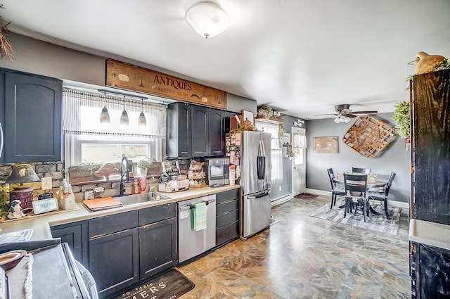 1849 Old Springfield Rd, New Holland, OH 43145 - kitchen featuring stainless steel appliances, a ceiling fan, light countertops, and pendant lighting