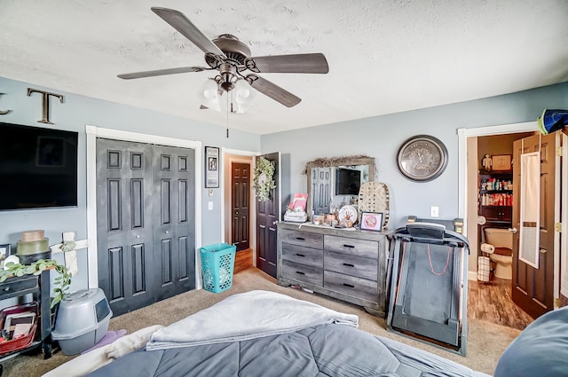 1849 Old Springfield Rd, New Holland, OH 43145 - carpeted bedroom featuring a closet, a textured ceiling, ceiling fan, and connected bathroom