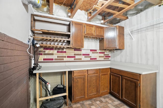 5632 Middle Falls St, Dublin, OH 43016 - kitchen featuring light countertops, brown cabinetry, and wooden walls