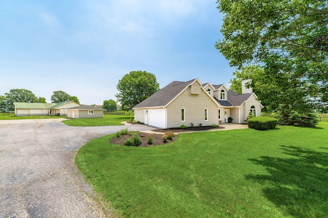 4909 Bixby Rd, Groveport, OH 43125 - view of front facade featuring a garage, driveway, a front lawn, and a chimney